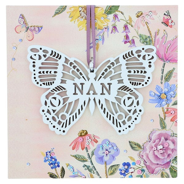 White wooden lace effect butterfly with nan text cut out on floral display board