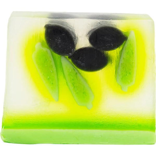 Olive Blossom Soap Slice from Bomb Cosmetics with olive oil and bergamot essential oils. With layers of green and yellow in a transparent slice with black olives and leaves. Glycerin soap and vegan friendly.
