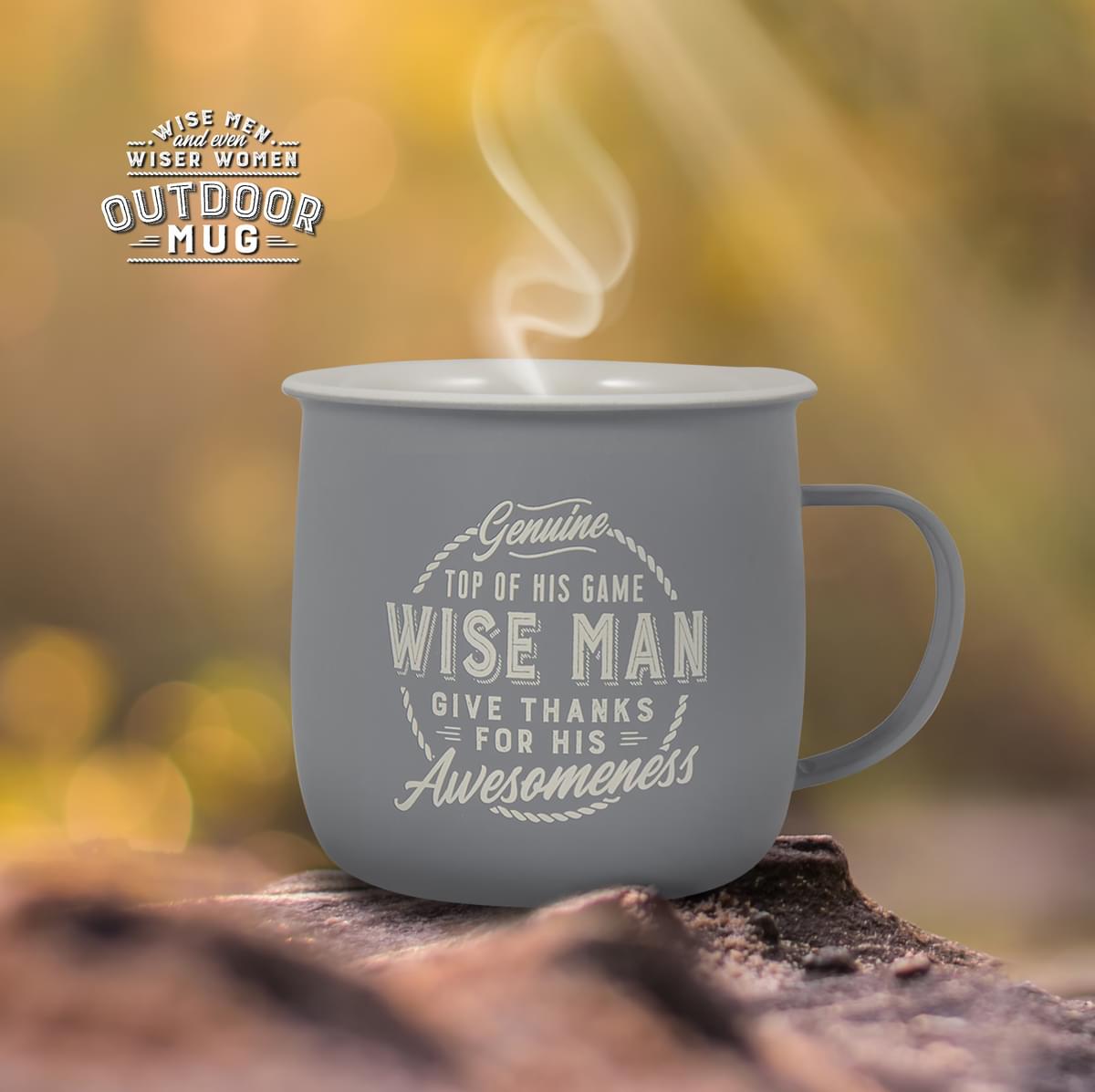 Outdoor Mug shown on the ground outdoors with steam rising from it.