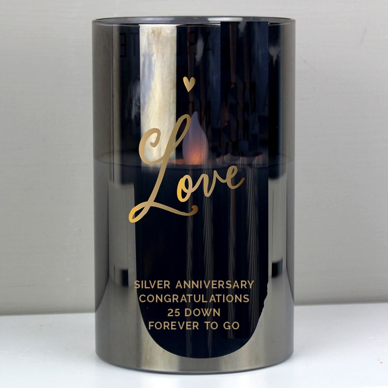 Candle holder with 'Love' and anniversary message on a white background