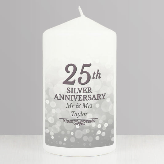 White candle with '25th Silver Anniversary Mr & Mrs Taylor' text on a grey background
