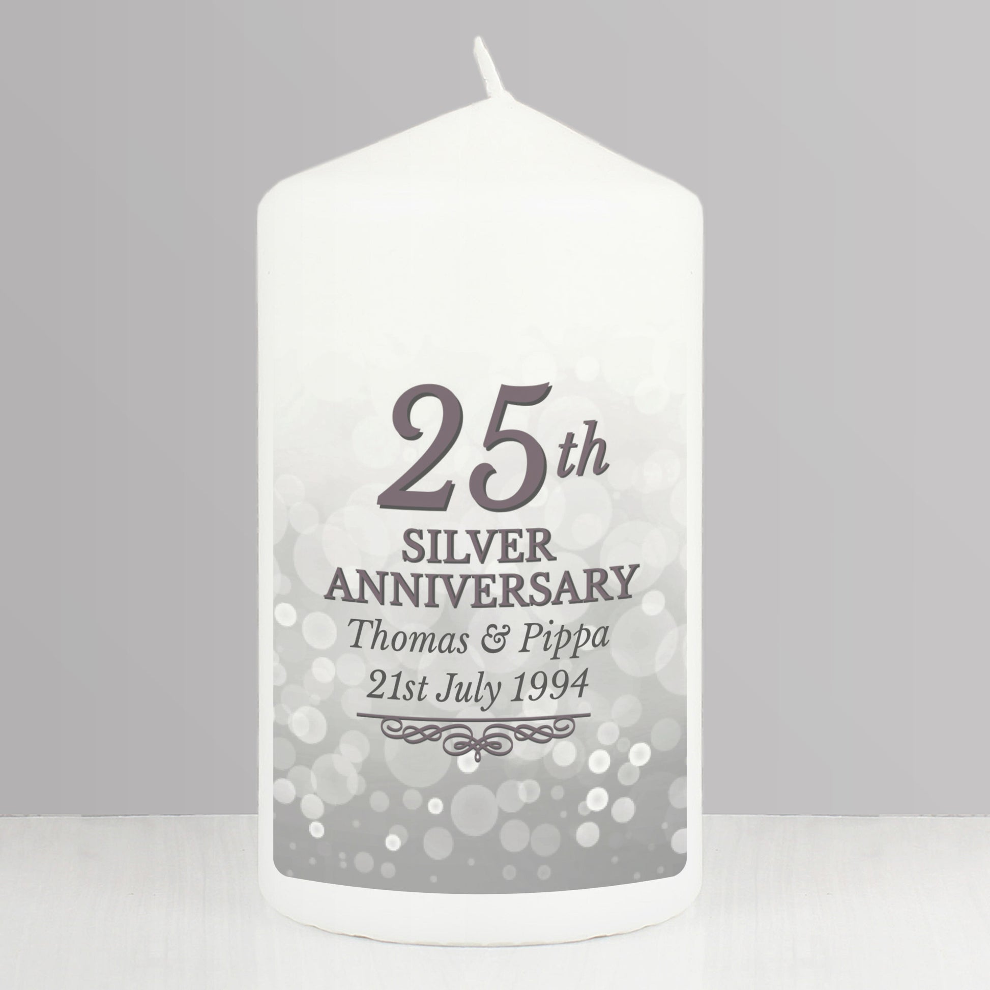 White candle with '25th Silver Anniversary' text on a grey background