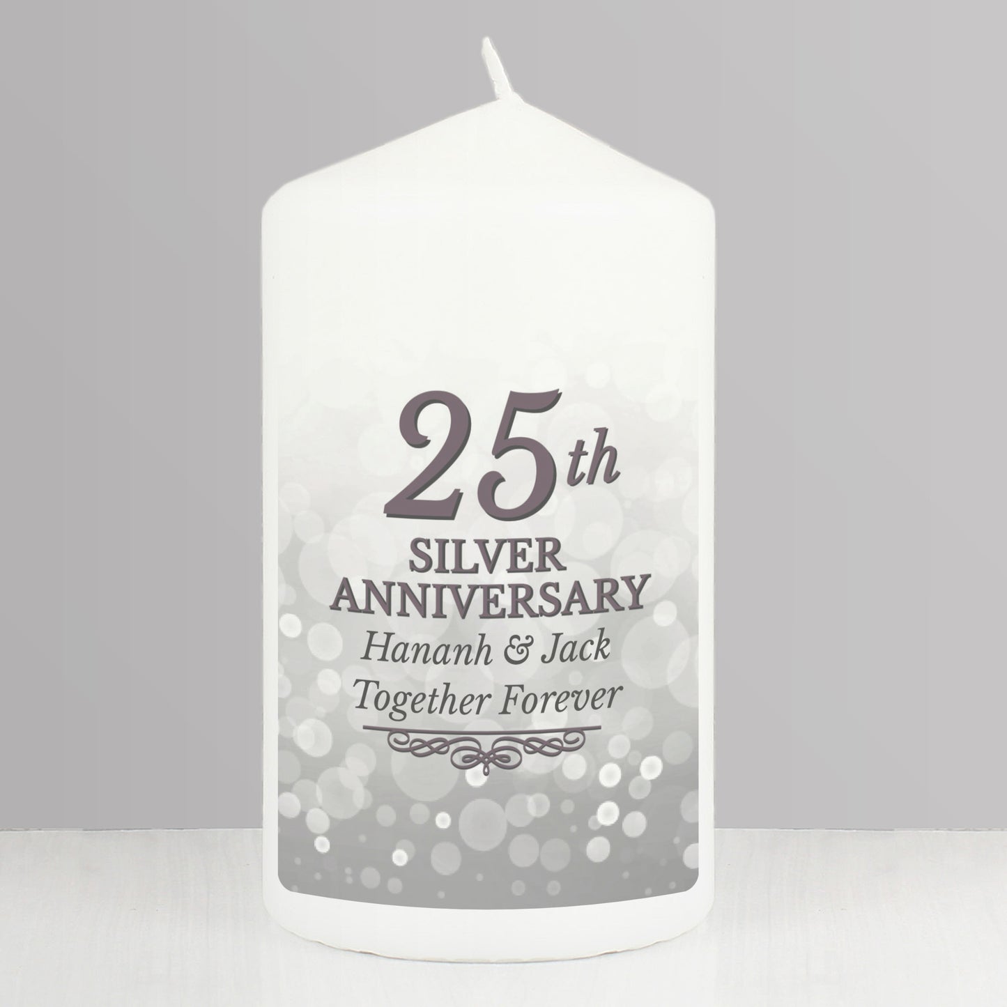 White candle with '25th Silver Anniversary' text on a grey background