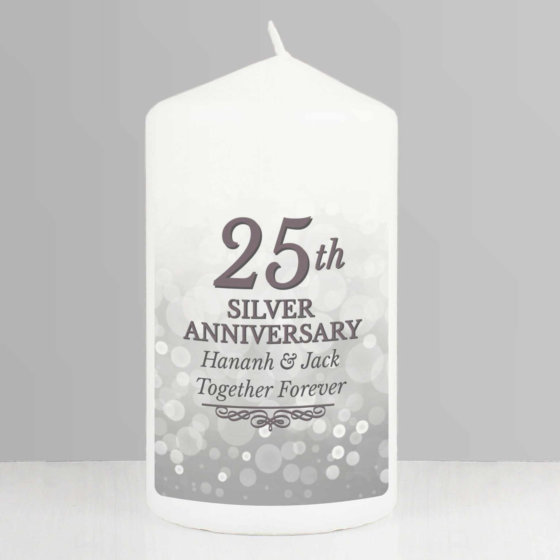 White candle with '25th Silver Anniversary' text on a grey background