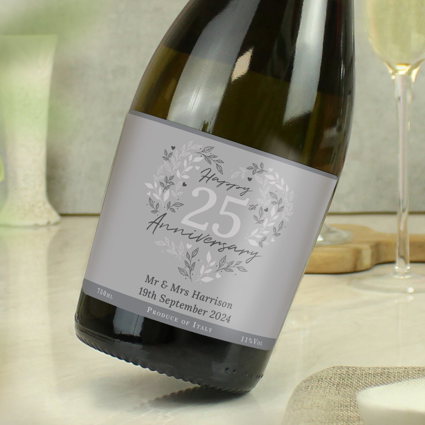 Wine bottle with a 'Happy Anniversary' label on a table.