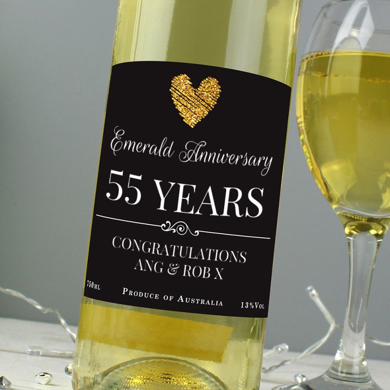 Bottle of white wine with a 'Sapphire Anniversary 45 Years' label next to a glass of wine.