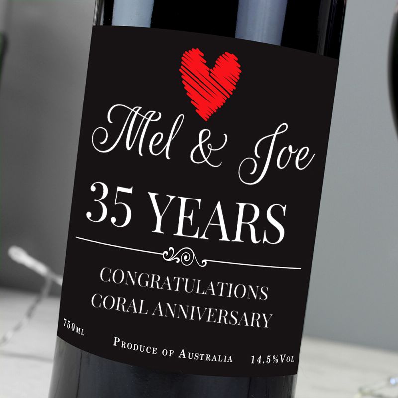 Wine bottle with a label celebrating 35 years of marriage, featuring a red heart.