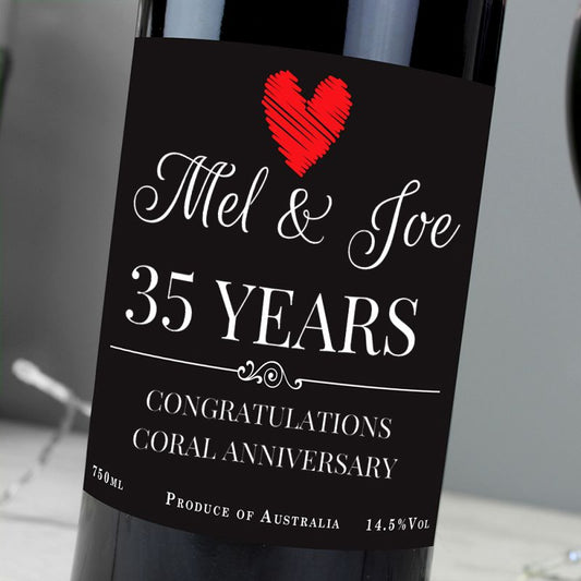 Wine bottle with a label celebrating 35 years of marriage, featuring a red heart.
