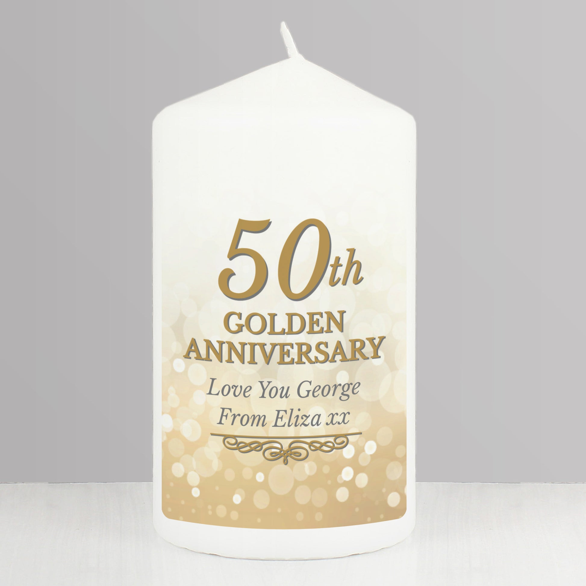 White candle with '50th Golden Anniversary' text on a grey background