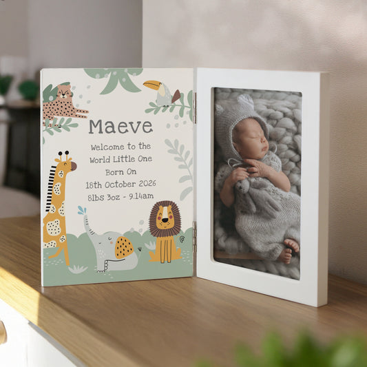Baby photo album with cartoon animals and baby photo on a wooden surface