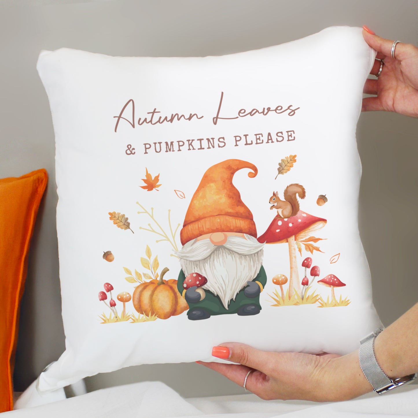 Decorative personalised cushion with autumn-themed design featuring a gnome, pumpkins, and text.