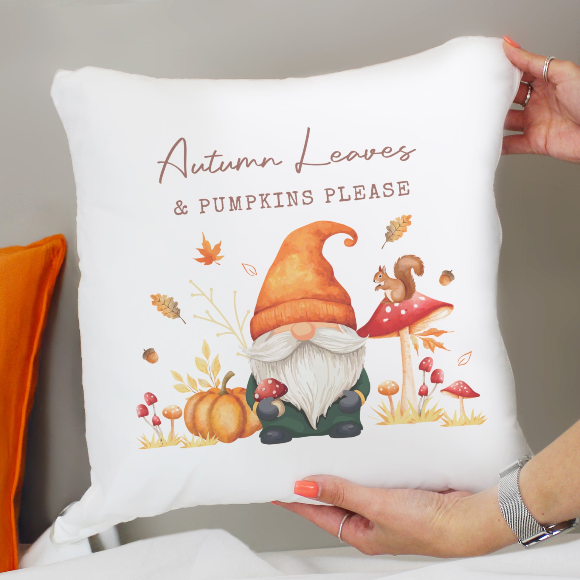 Decorative personalised cushion with autumn-themed design featuring a gnome, pumpkins, and text.