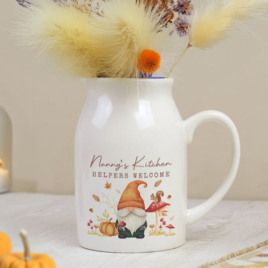 White mug with 'Nanny's Kitchen Helpers Welcome' text and gnome design, filled with dried flowers.