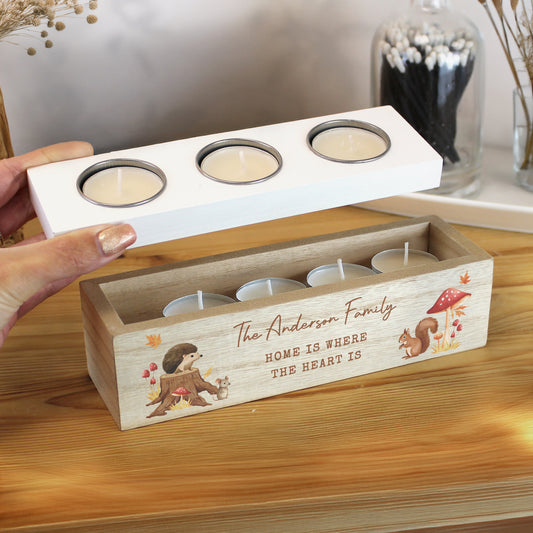 Wooden candle holder with tea light candles and autumn-themed graphics and personalised text on a wooden surface.