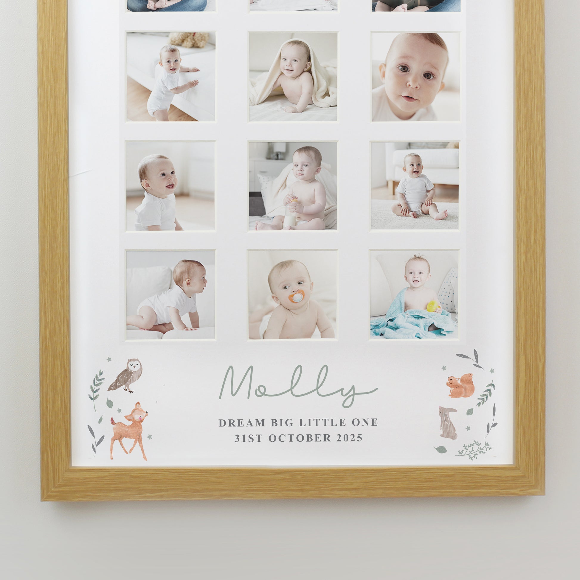 Framed collage of a baby's photos with decorative elements and text on a white wall.