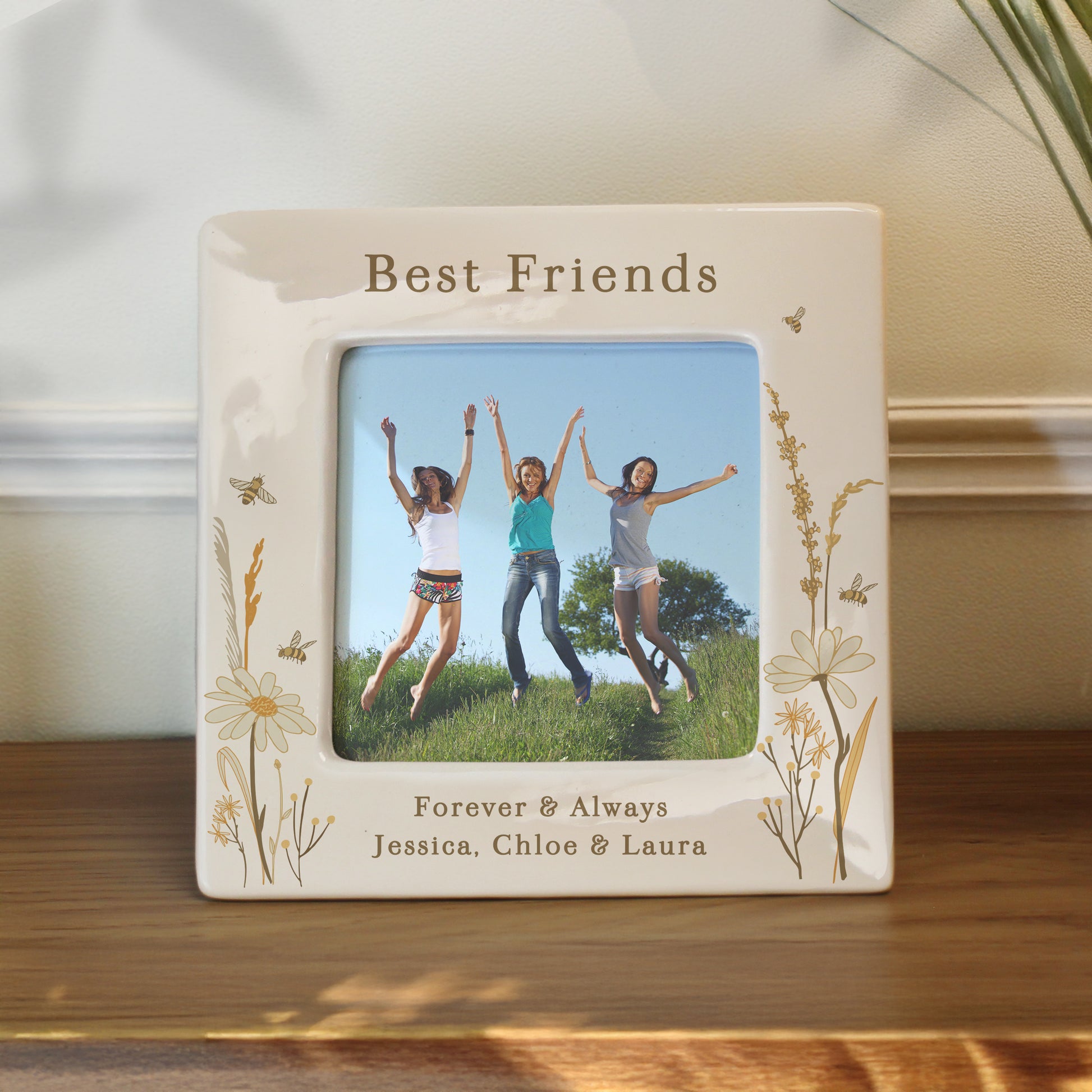 Personalised photo frame with 'Best Friends Forever & Always' text and floral designs, displaying a photo of three people jumping.