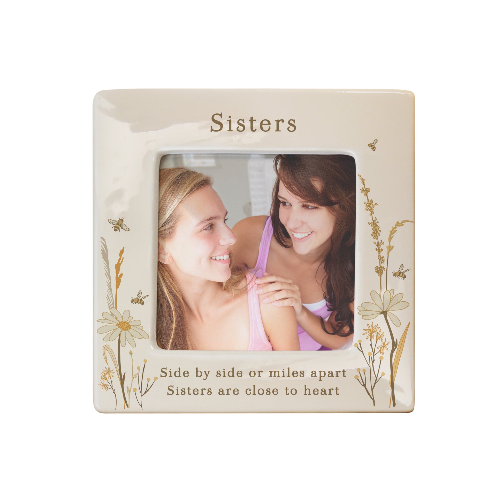 Decorative photo frame with floral designs and text about sisters on a white background