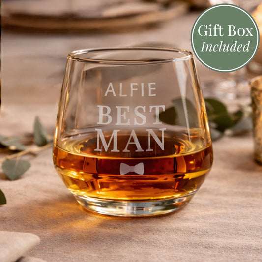 Glass of whiskey with 'ALFIE BEST MAN' engraving on a wooden surface, gift box included.