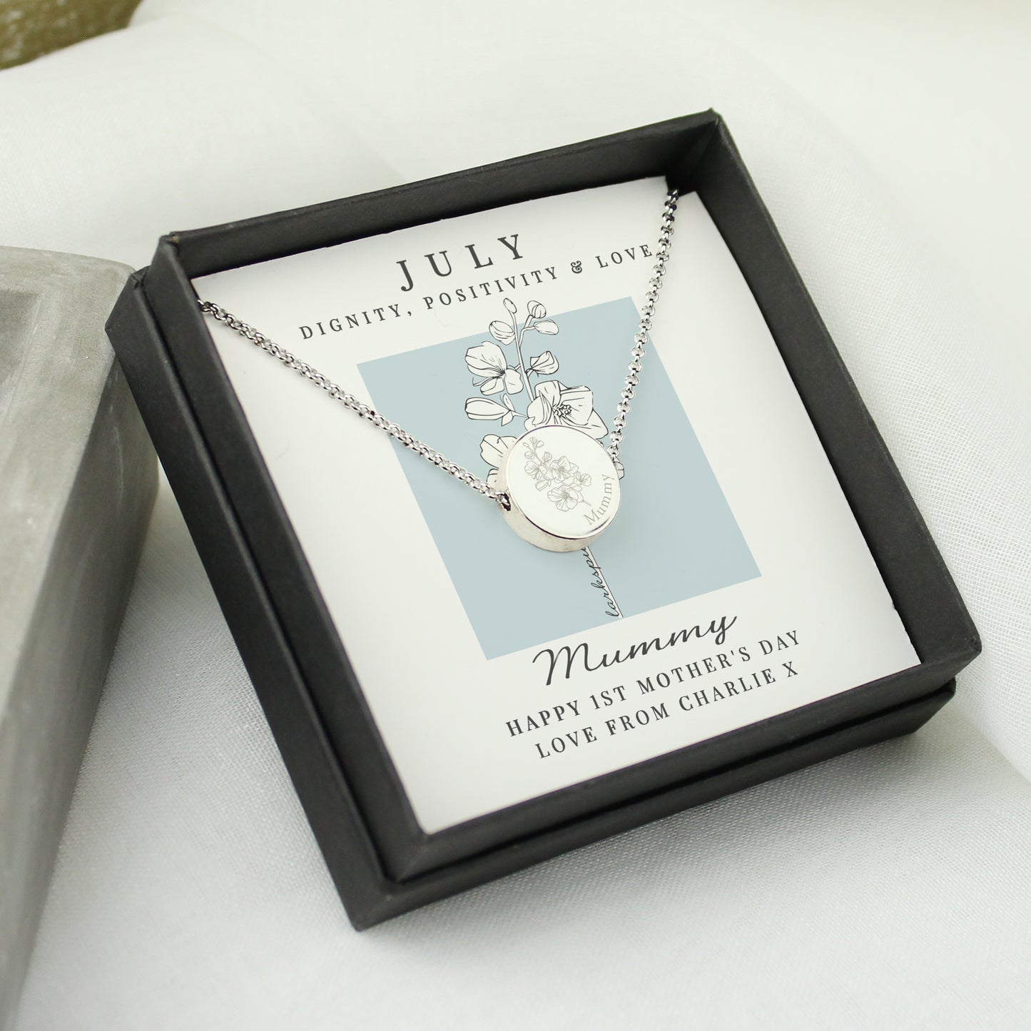 Necklace in a black box with a July backing card for Mother's Day