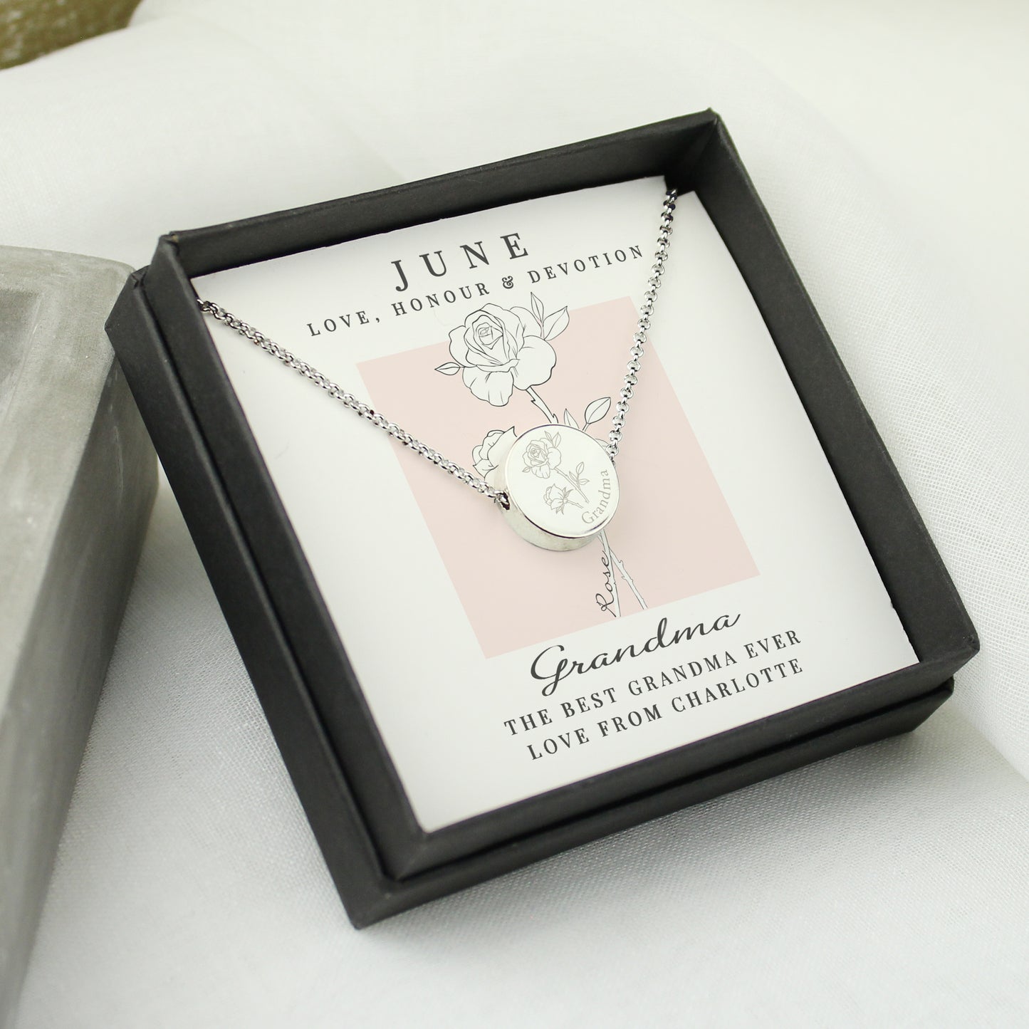 Silver coloured necklace in a black box with personalised message