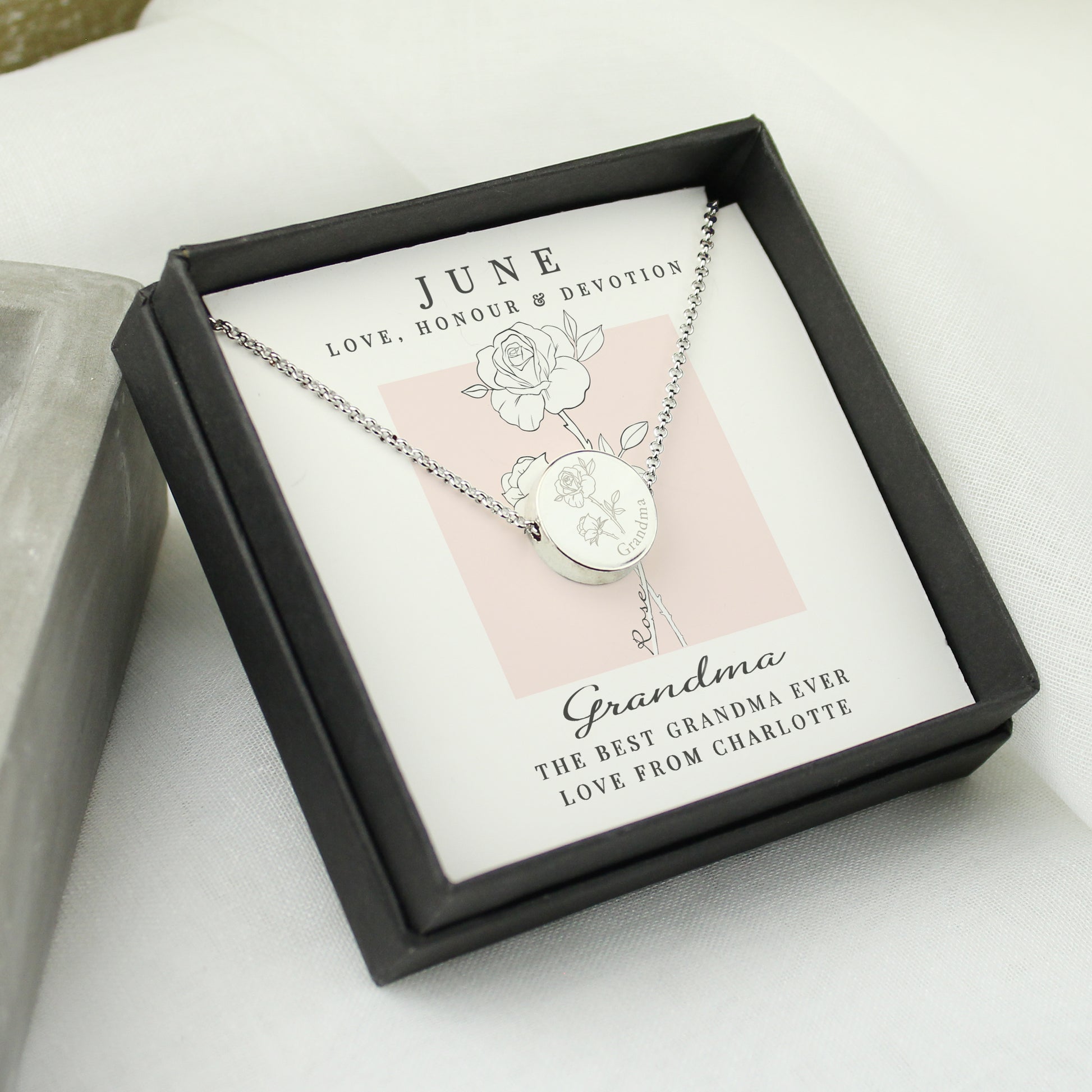 Silver coloured necklace in a black box with personalised message