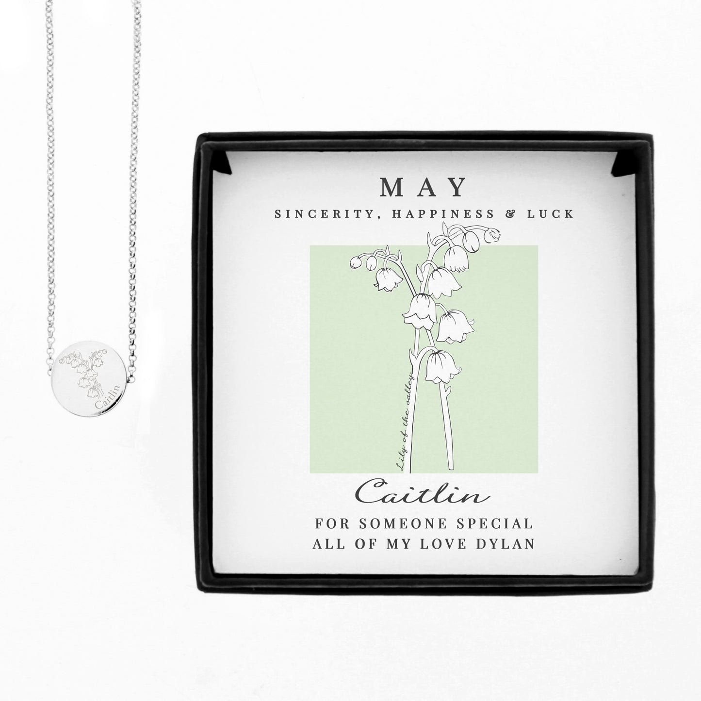 Necklace with a heart pendant in a decorative box with floral design and text.
