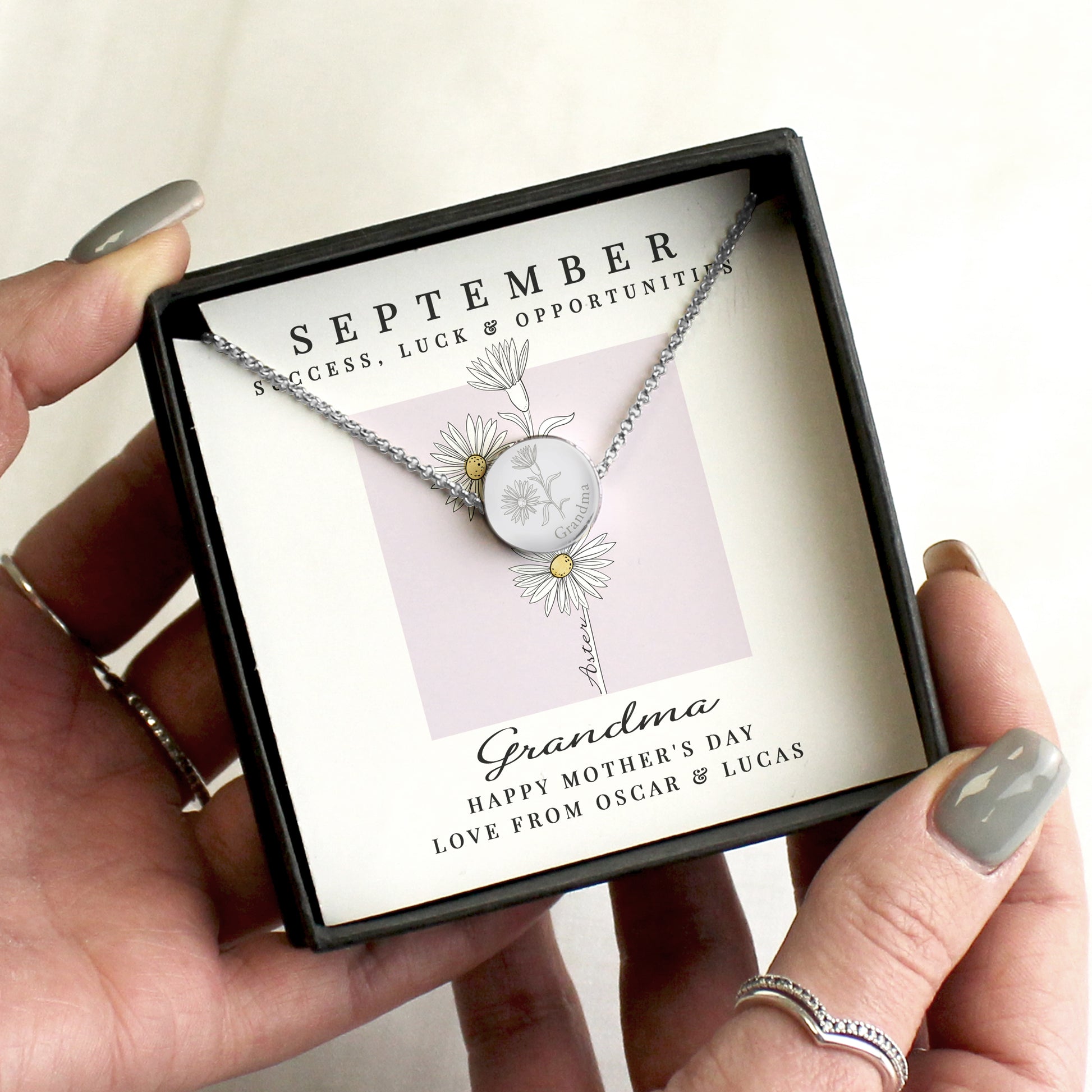 Necklace in a gift box with personalised message, held by a hand.