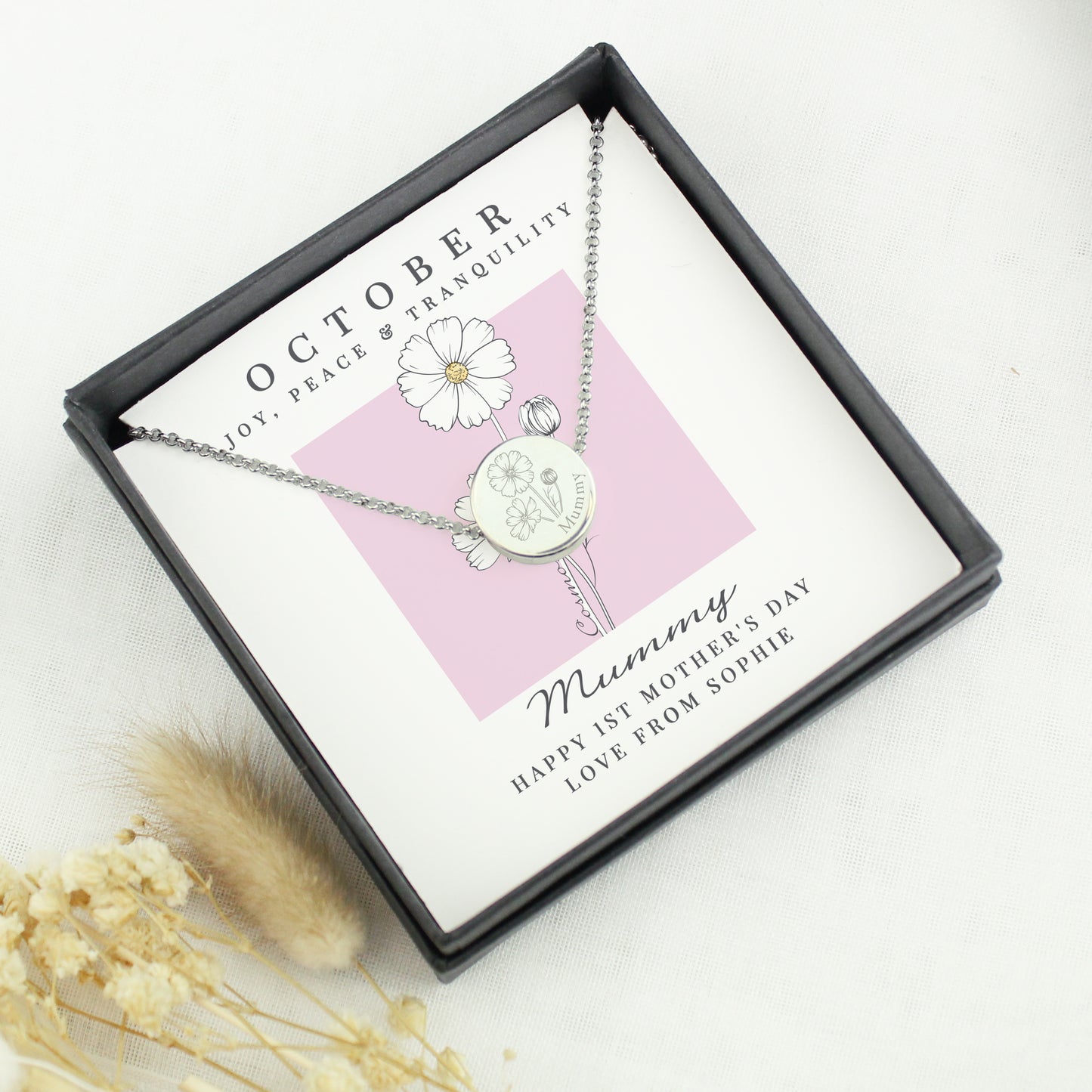 Necklace with a pendant in a gift box with a card, on a light background