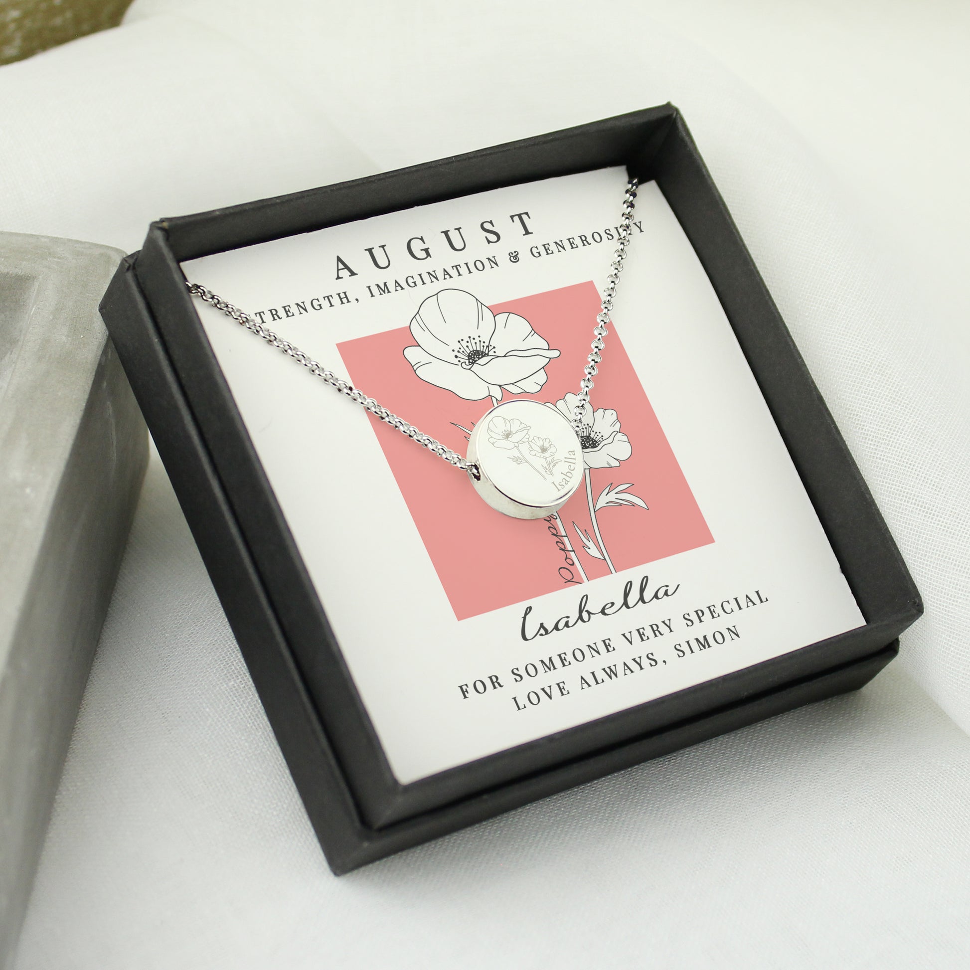 Necklace in a gift box with an August birthstone card on a white surface