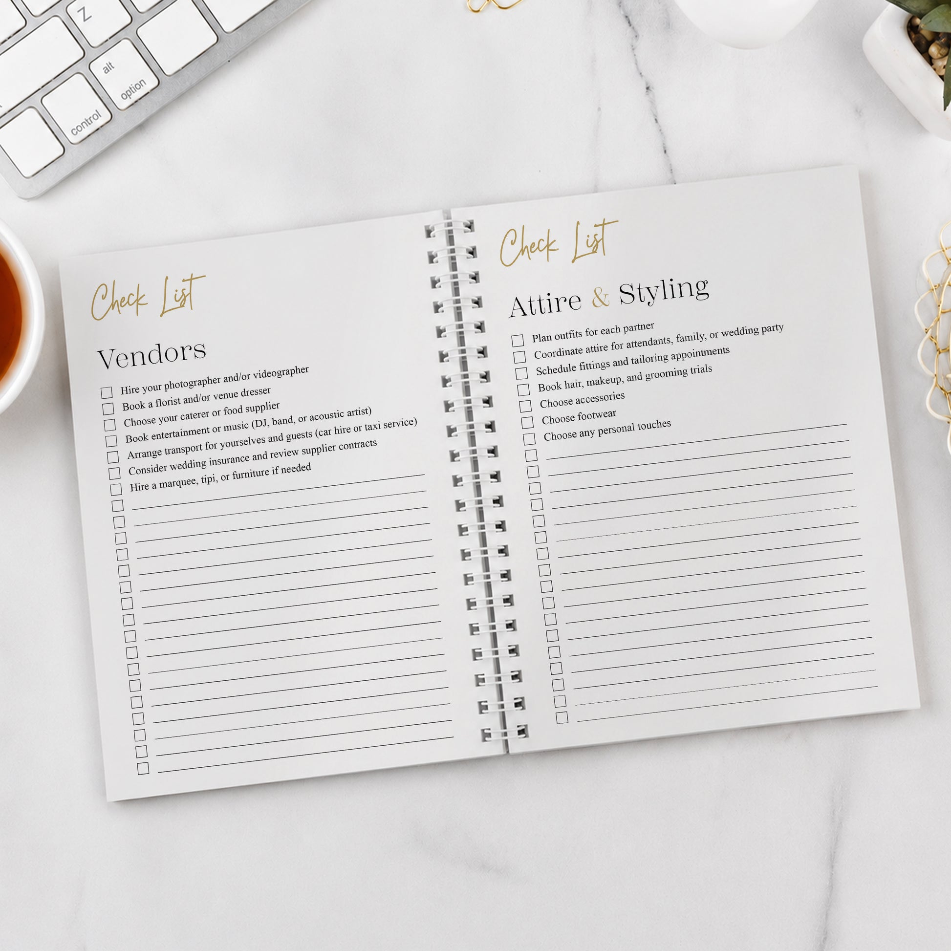 Open notebook with checklists for vendors and attire & styling on a white surface.