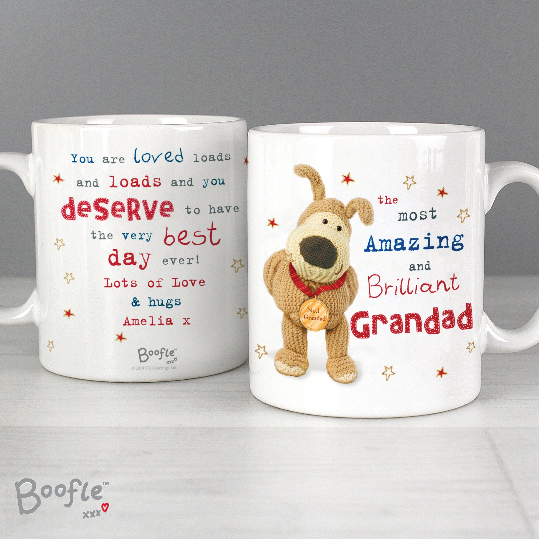 Two white Boofle mugs standing on a white shelf. 