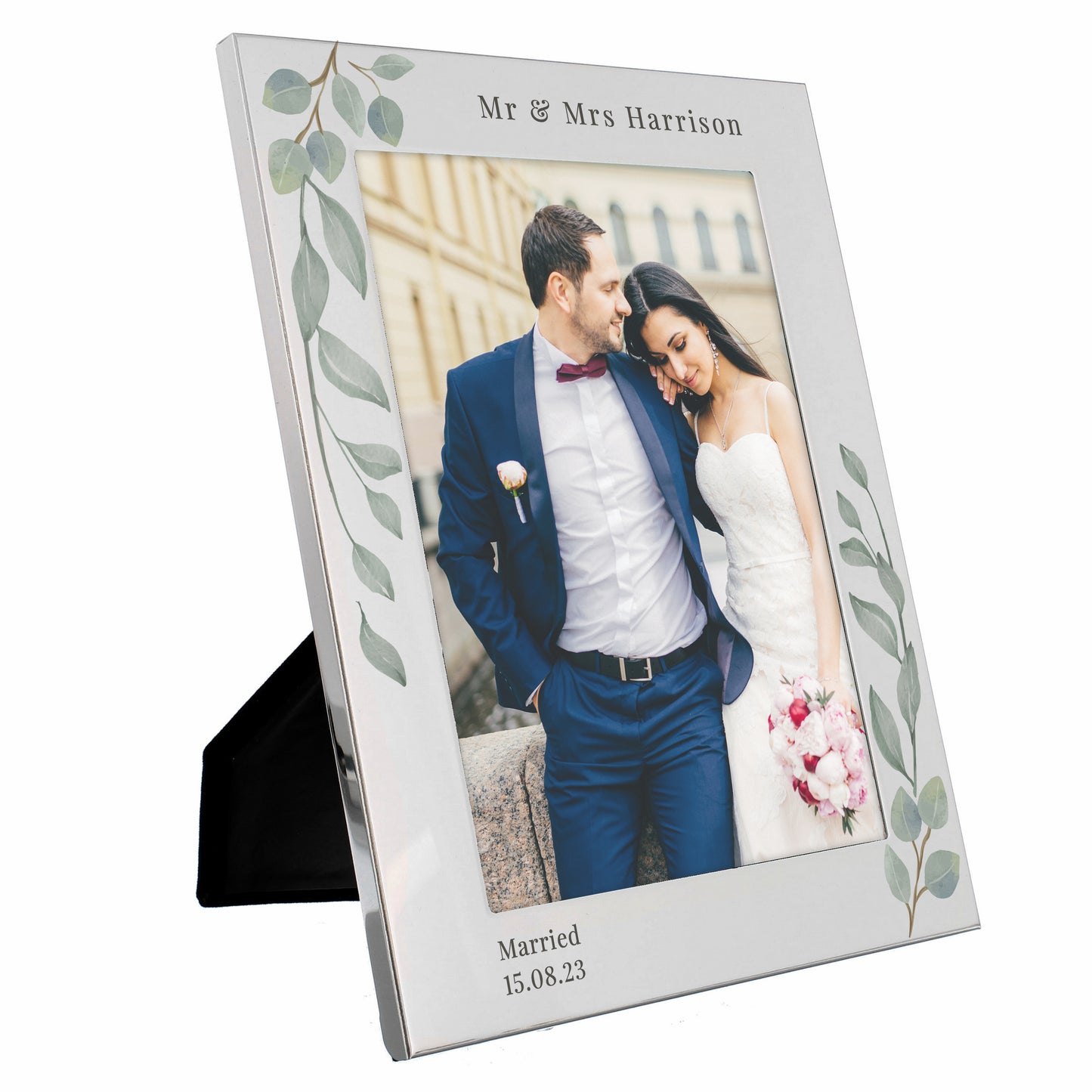 A silver 5x7 photo frame with a botanical design, personalised with a message, displaying a couple's wedding photo.