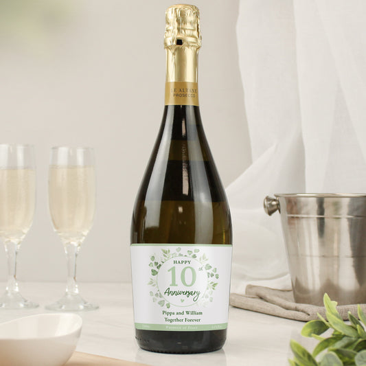 Bottle of prosecco with Happy 10 Anniversary label shown with wine bucket and flutes