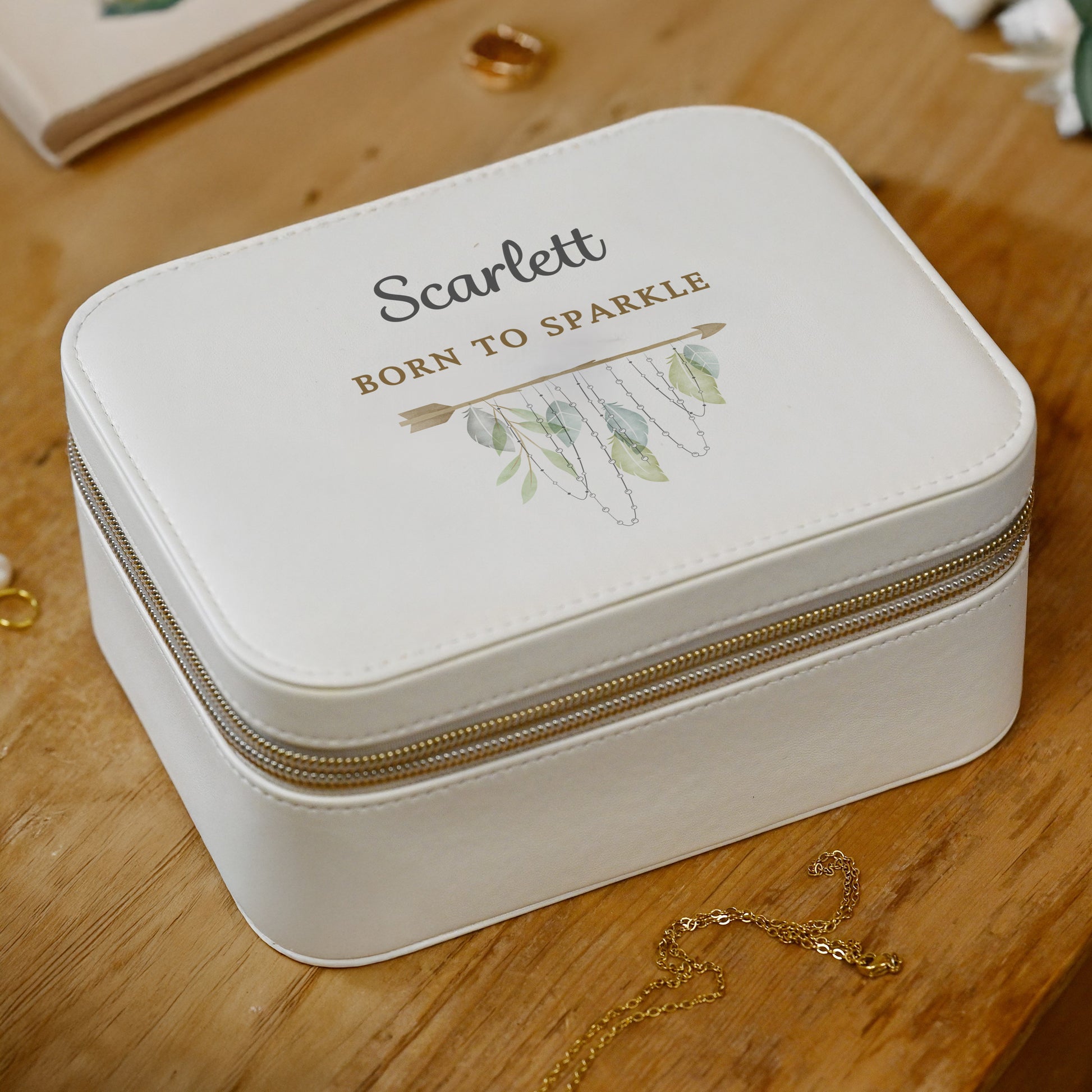 White jewelry box with 'Scarlett' and 'Born to Sparkle' text on a wooden surface