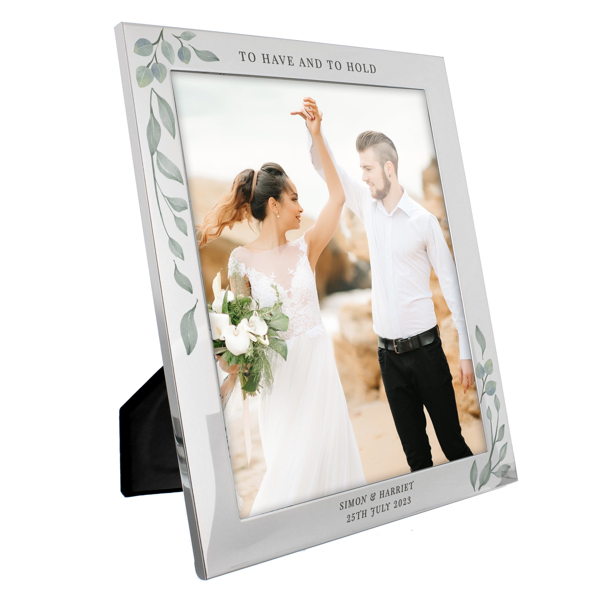 Silver frame with leaf decoration showing wedding photo. Personalised with To Have And To Hold above the photo and Simon & Harriet 25th July 2023 below it.