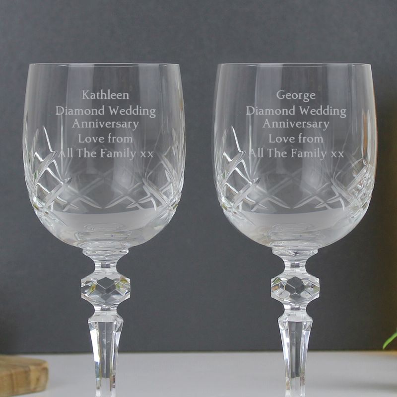 Two crystal wine glasses with personalised diamond anniversary message shown on a grey background.