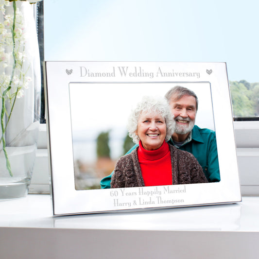 Personalised diamond wedding anniversary photo frame with a couple's portrait on a table.