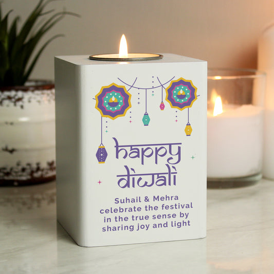 Wooden personalised tealight holder. Hanging lantern images and Happy Diwali text. Personalised text reads - Suhail & Mehra celebrate the festival in the true sense by sharing joy and light. Shown next to lit candle and plant.