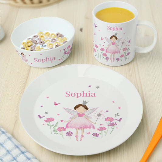 Children's tableware set with fairy design and 'Sophia' branding on a wooden surface.