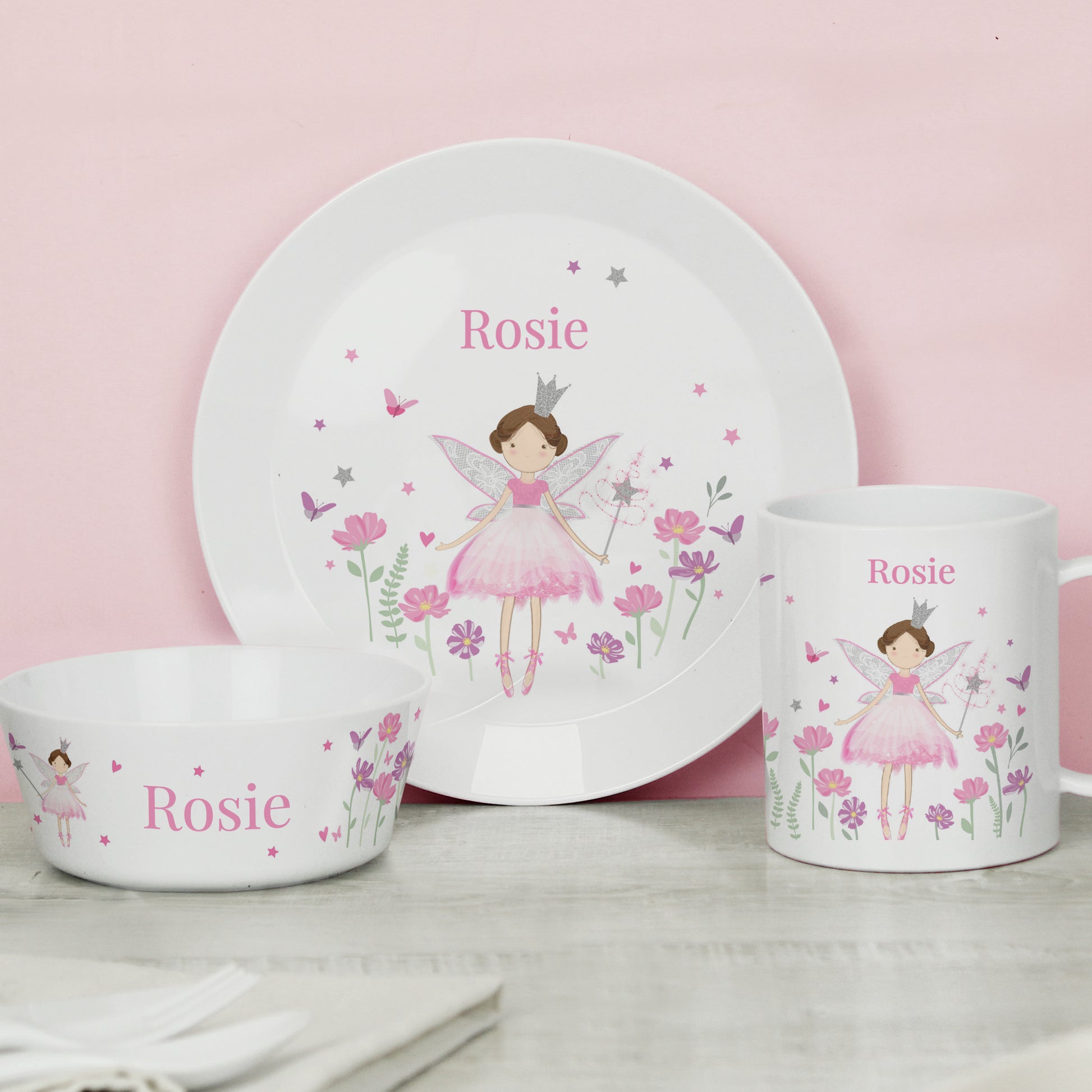 Children's dinnerware set with fairy design and 'Rosie' text on a pink background