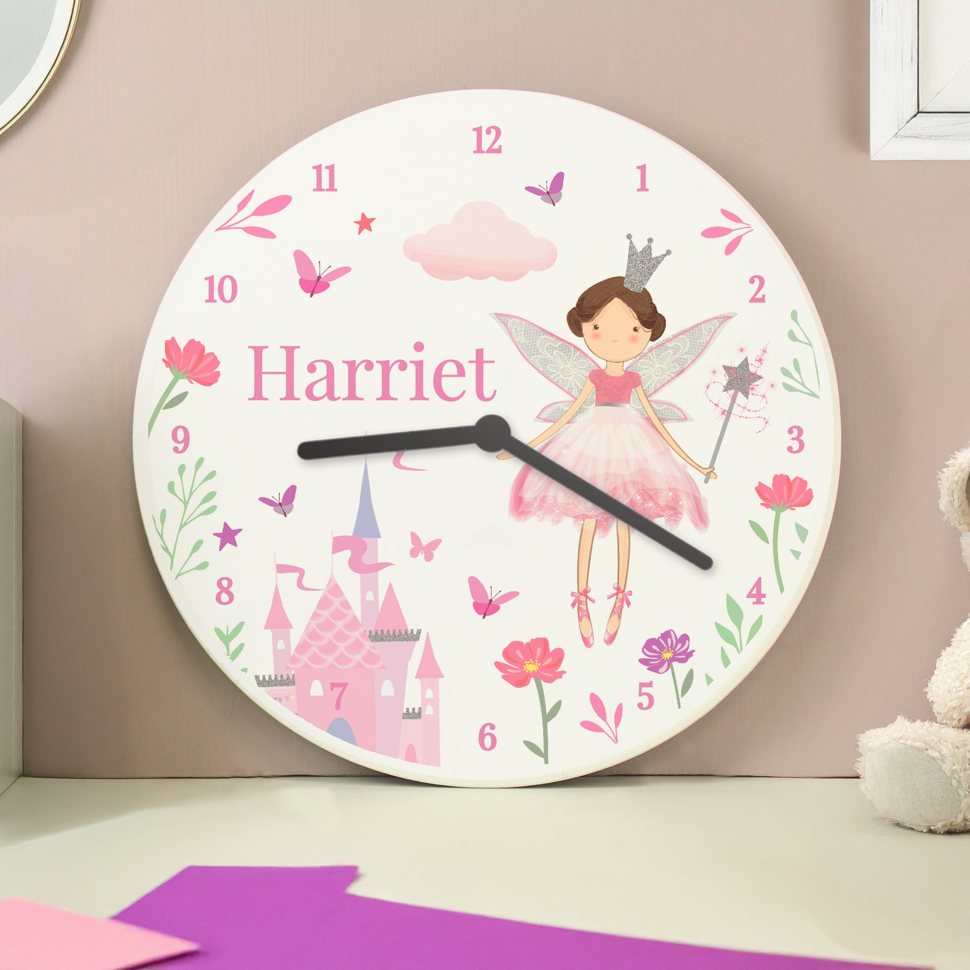 Children's wall clock with fairy design and name 'Harriet' on a pink background