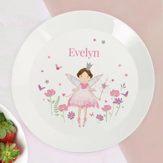 Children's plate with a fairy design and the name 'Evelyn' on a pink background