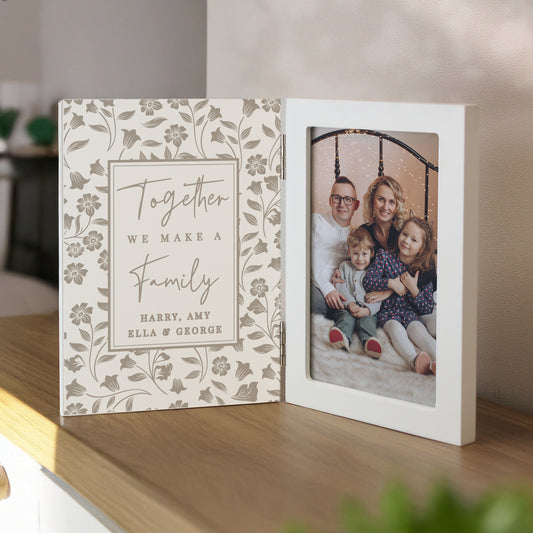 Personalised photo album with floral design and family photo on a wooden surface.