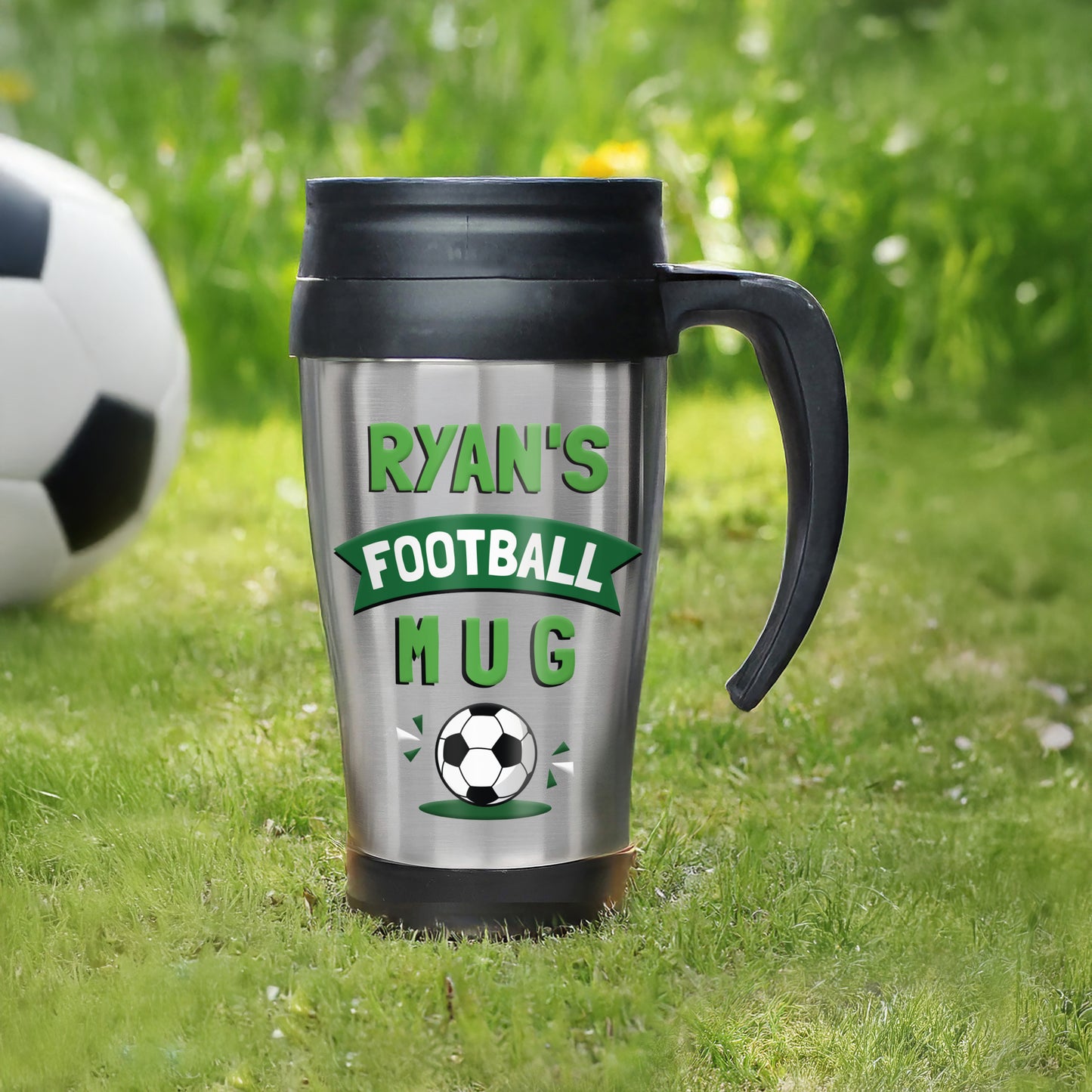 Personalised football mug with 'Ryan's Football Mug' text on grass with a soccer ball.