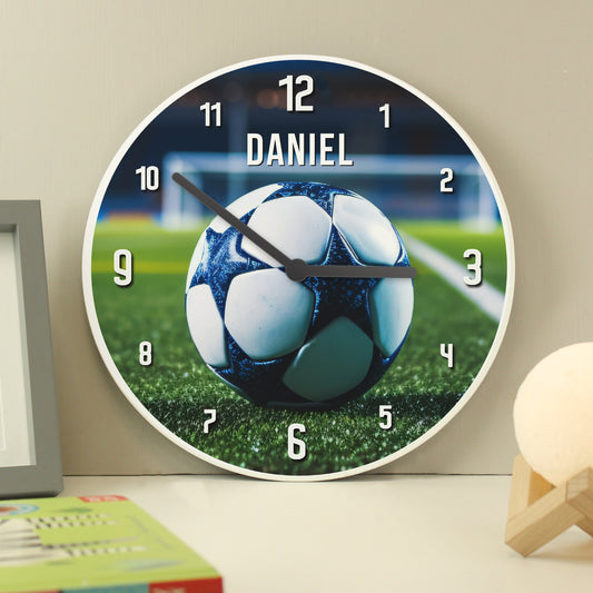 Wall clock with soccer ball design and 'DANIEL' on a grass field background