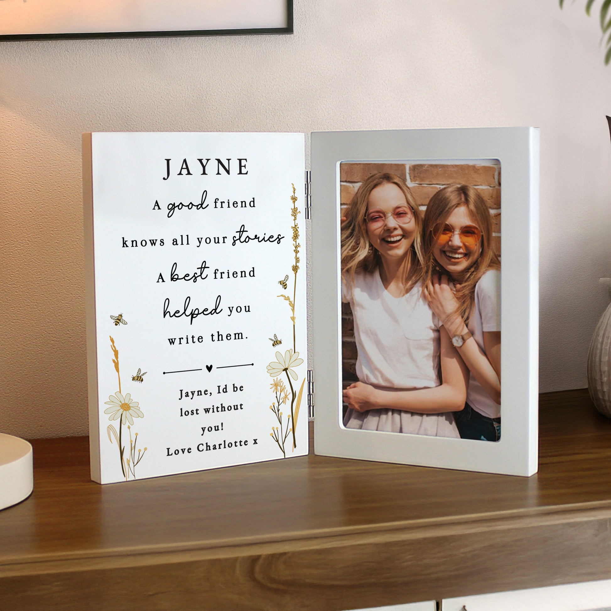 Personalised photo frame with a message and a photo of two people on a wooden surface.