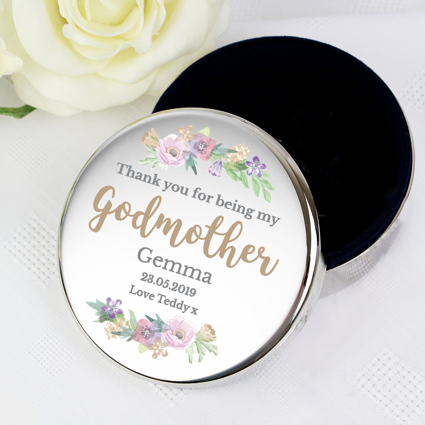 Round tin with floral design and text on a white background