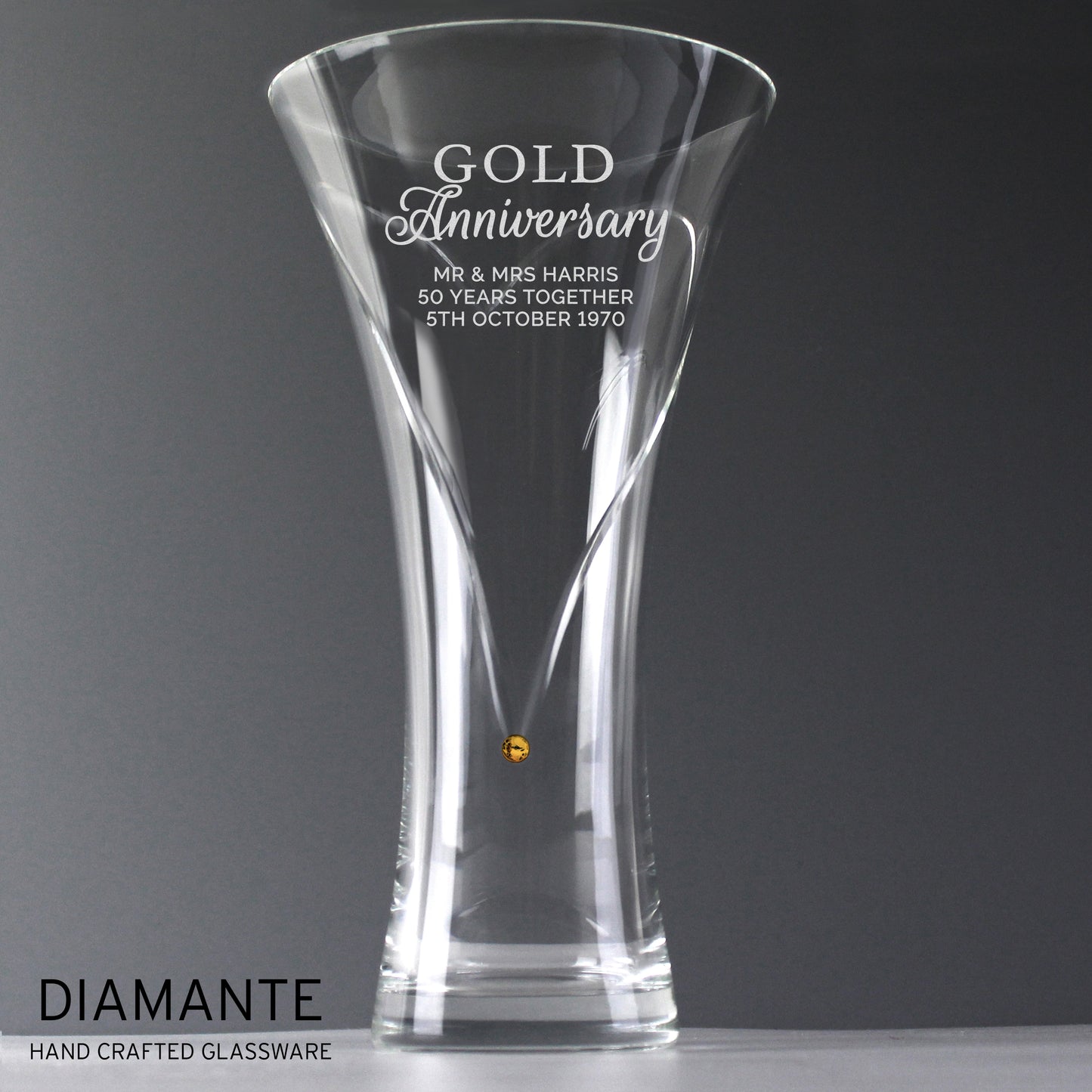 Clear glass vase with engraved Gold Anniversary text on a grey background, featuring the brand 'Diamante'.