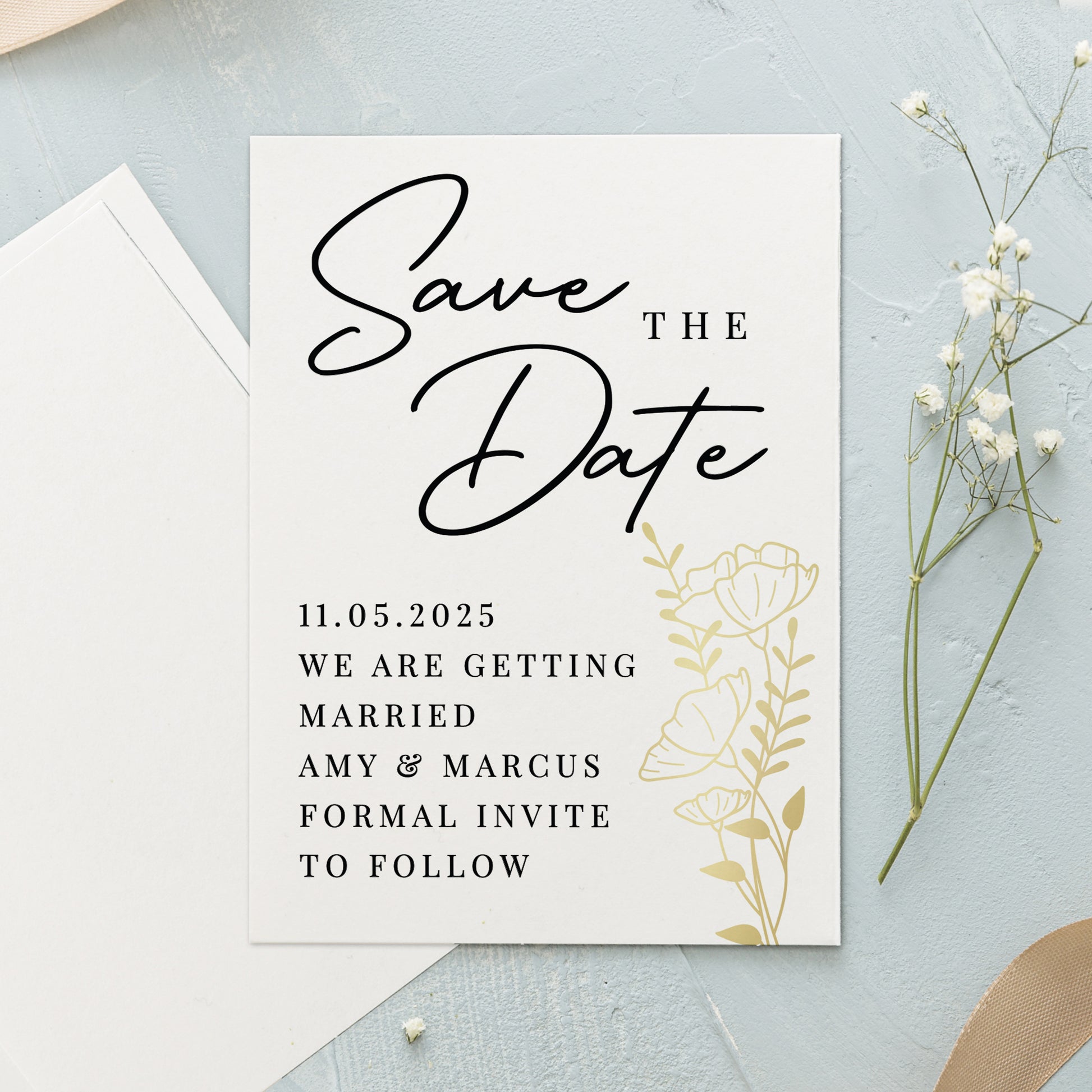 Save the Date card with floral design on a light blue background