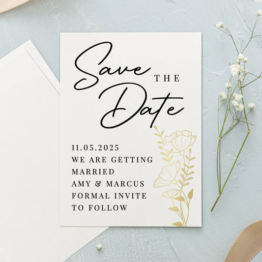 Save the Date card with floral design on a light blue background